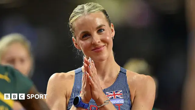 Head and shoulders of Keely Hodgkinson, wearing a blue GB vest with thin white stripes, standing with her hands together in front of her chest