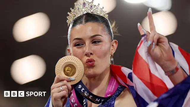 Gold medalist Amy Hunt of Team Great Britain poses for a photo with her medal, tiara and national flag after victory in the Women's 200m Final