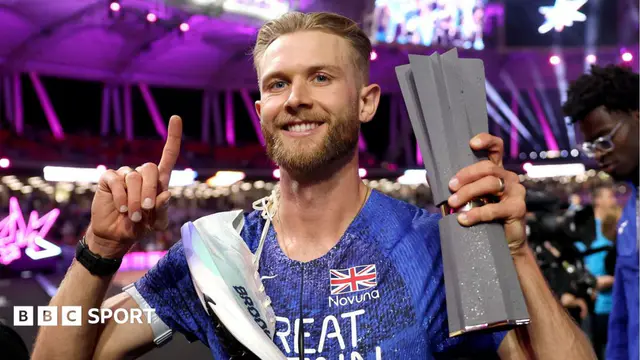 Josh Kerr celebrates with his Ultimate Championship trophy after winning the men's 1500m